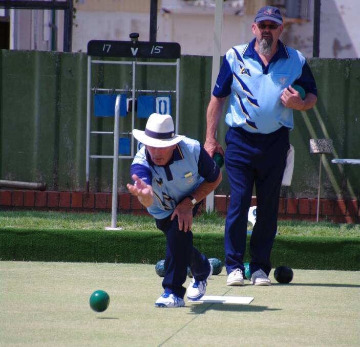 ROLLING GREENS: Coopie Baker sends down a shot during the weekend's bowls tournament at Bombala as Pat Lomas awaits his turn.