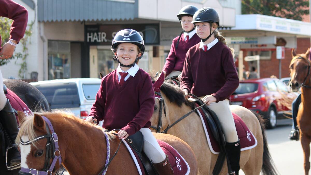 ON PARADE: Delegate Pony Club members ride down the main street of Bega during the annual Easter weekend Camp.