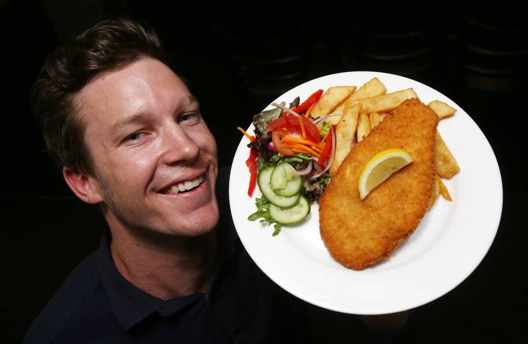North Gong Hotel manager Steve Moore with the $7.50 schnitty that is still on the  menu, despite claims to the contrary. Picture: Robert Peet 