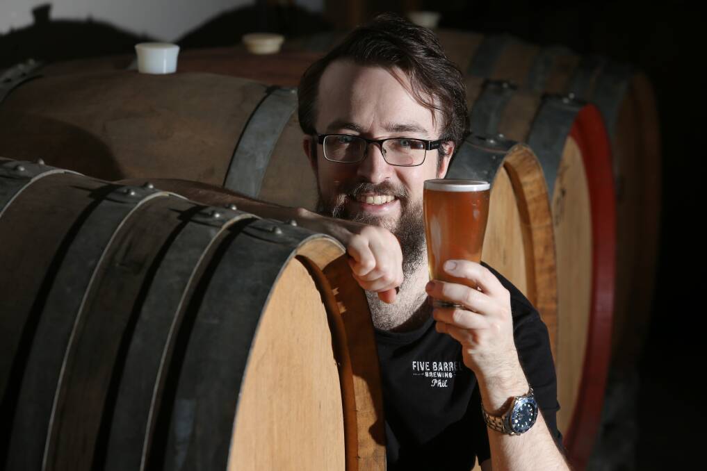 Wollongong brewer Phil O'Shea with the chardonnay barrels he used to age 600 litres of his golden ale. Picture: Robert Peet