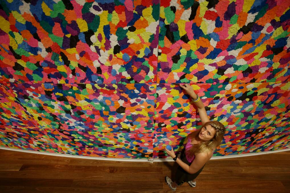 FUN FOAM: Rosie Deacon with her wall installation as part of the interactive Sensorium exhibition to open at Wollongong Art Gallery, suitable for people with varying abilities. Picture: Robert Peet