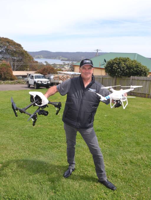 Ian Edwards with his latest professional drone or unmanned aerial vehicle on the left and a smaller amatuer model less than 2kg covered by the new CASA legislation.