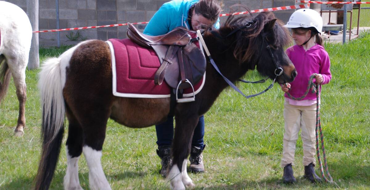 GEAR CHECK: Delegate Pony Club mum Sinead Cameron checks Billie Farran's pony before the games started at the Club rally in Delegate on Sunday.