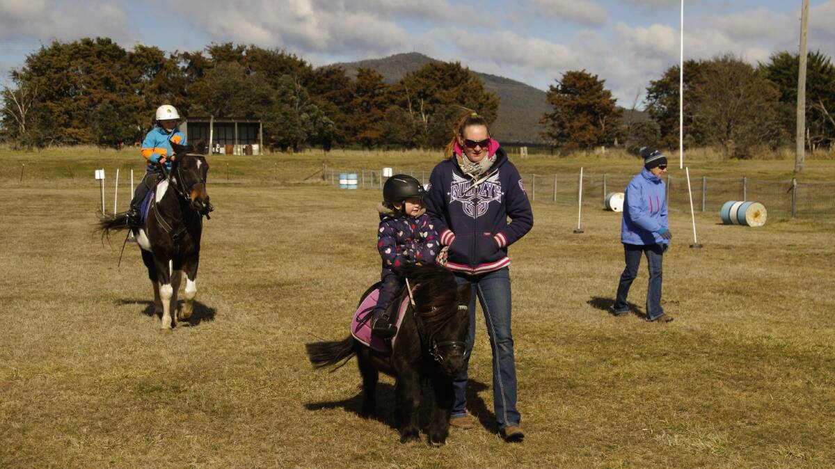 Pony clubbers Kell, Myah and Dustin Voveris with instructor Julie Peadon at the Delegate Pony Club rally in Delegate on Saturday.