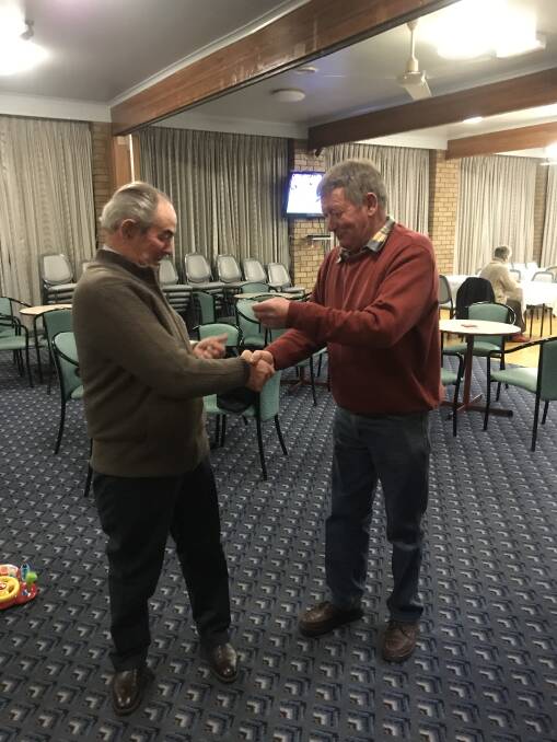 Delegate Golf Club president Coopy Baker presents Jackson Standen with his pennants award at Delegate golf club.