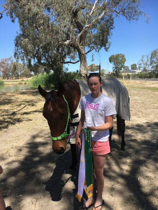 Rochelle Voveris and her Australian Stock Horse, Dynamite, with the ribbons won at the Pony Qualifying Championships in Roma, Queensland, recently.