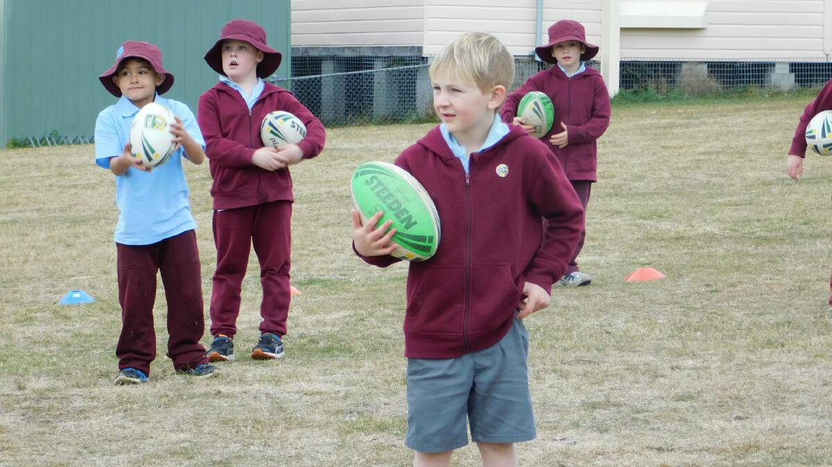 Bombala Public School K-6 student, Kaiden Simpson learning how to play rugby league.
