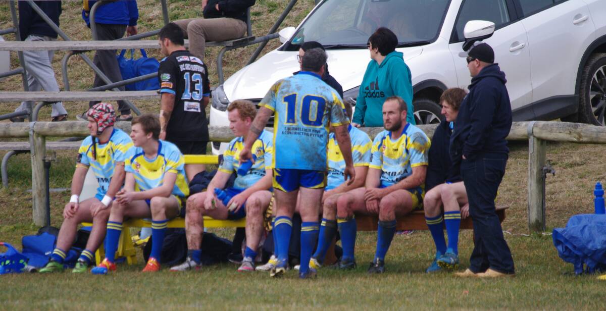 MUDDY LEAGUE: Bombala Blue Heelers reserve grade players watching their team battling it out against the Moruya Sharks in Bombala on Sunday.