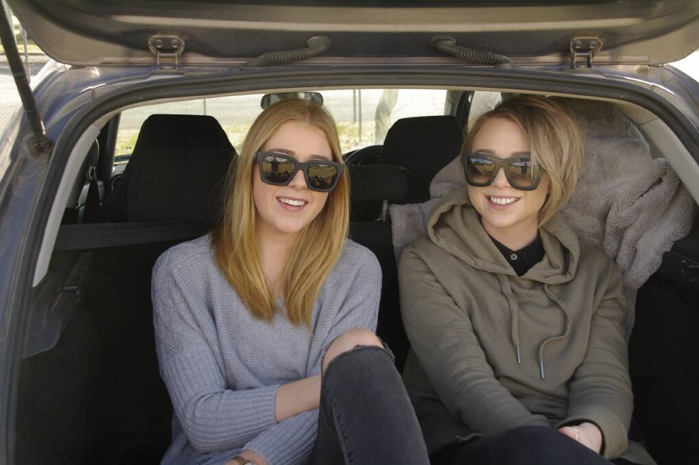 Keeping cosy in the back seat of their car at Sunday's footy were Abbey Stafford and Emily Stroud of Merimbula.