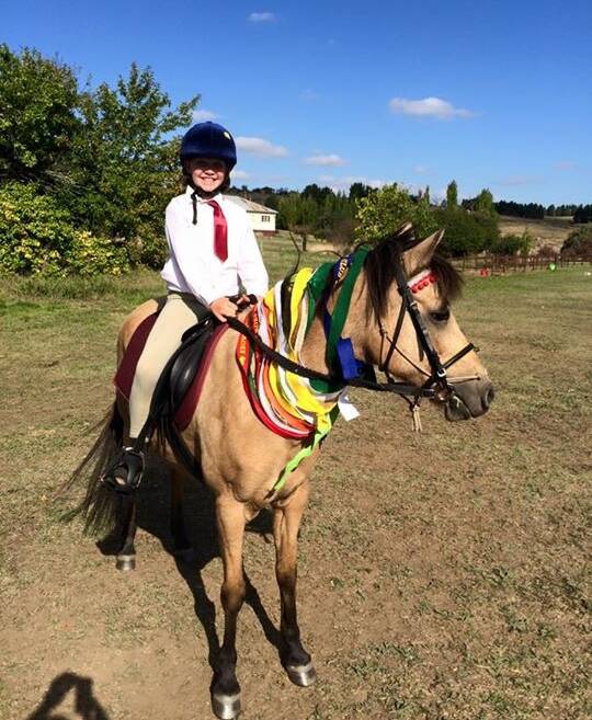 WINNER: Delegate Pony Club rider Emily Vincent on her mount Missy with all her ribbons she won during April's series of gymkhanas and rallies.