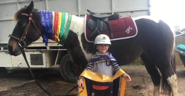 Delegate Pony Club rider Dustin Voeris and his pony Jigsaw with a hoard of ribbons won at the Cooma Pony Club rally day recently.