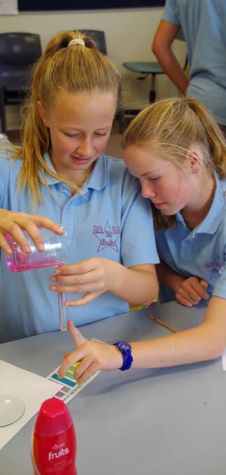 Zara Badewitz and Jess Vincent measure out the liquid for their science experiment during the science afternoon in preparation for Year 6's transition to High School.