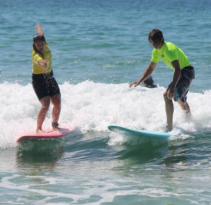 SURFS UP: Bombala High School students Janine Jamieson and Jayden Robinson were taught how to surf on a recent school excursion to Eden.