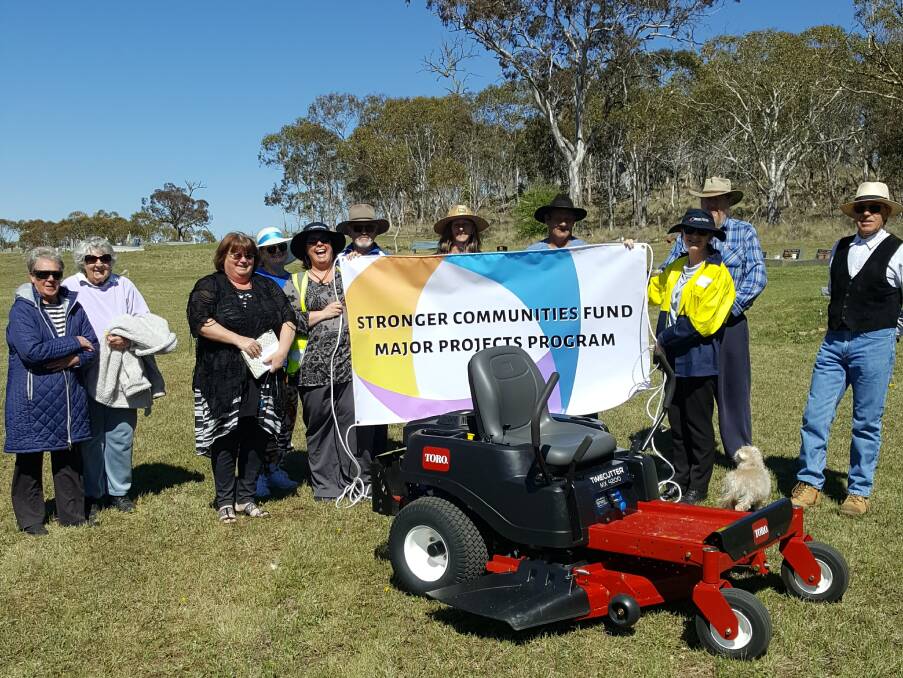 LAWN MOWER: Snowy Monaro Regional Council staff, the Nimmitabel Cemetery Committee and Advancement Group at the mower presentation.