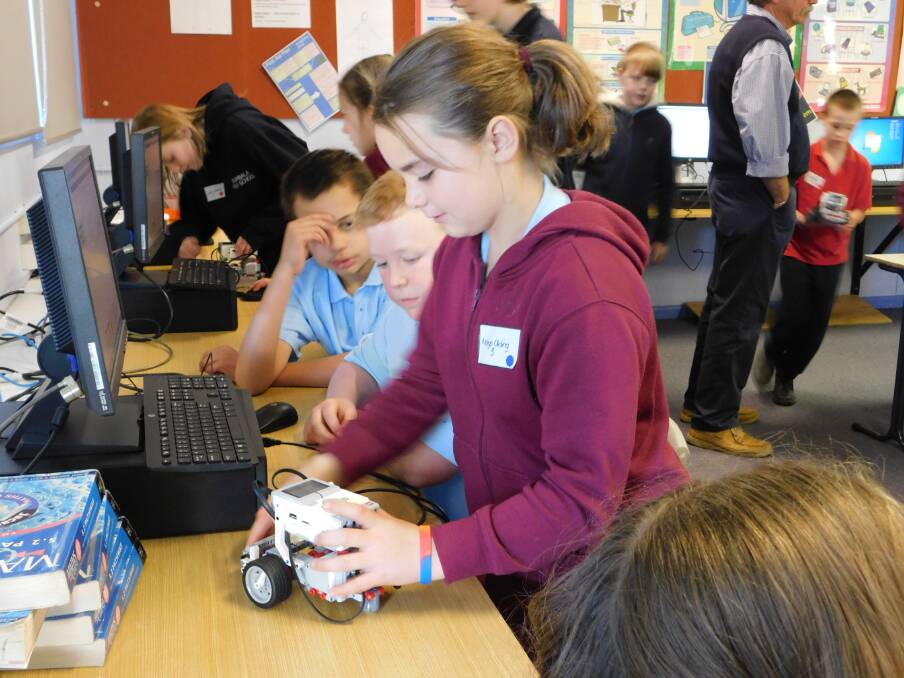 MIDDLE SCHOOL: Maya Olding and Jye Miles from Bombala Public School and Maleek Rangi from St Joseph's working with computer coding and robots.