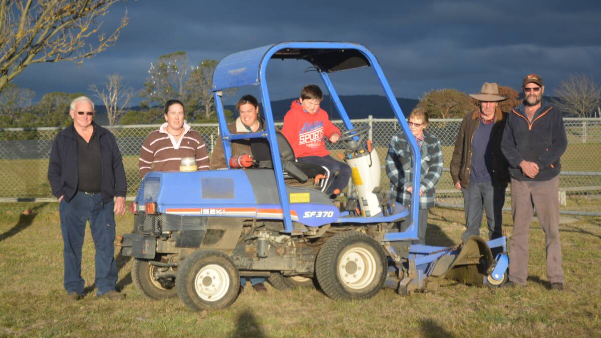 The Delegate sports ground committee and their new ride-on lawn mower.