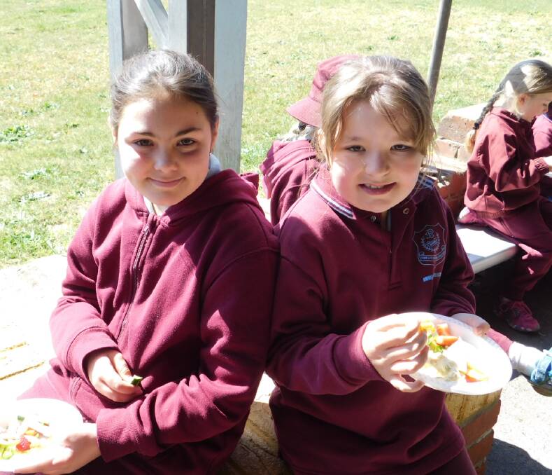 Enjoying eating their fruit and vegie crunch at Bombala Public School are Taya Douch and Emma Richardson.
 