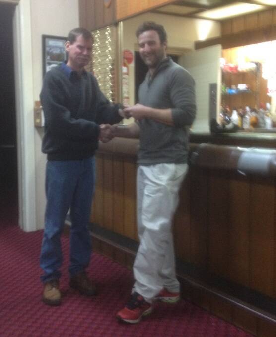 HOLE-IN-ONE: Simon Stephen is presented with the $2883 prize for his hole-in-one on the 17th hole by Bombala Golf Club president Brendan Weston.