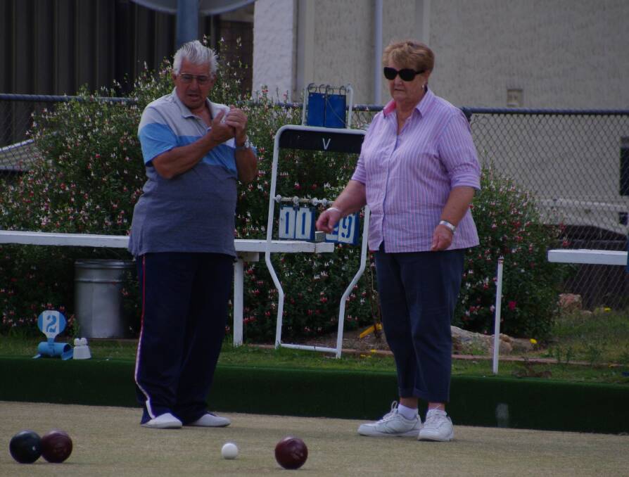 Chris X and Doreen Dent check out what bowl is closest to the kitty during a game of lawn bowls in Bombala over the weekend.