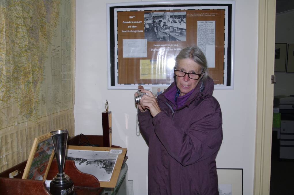 Christine Parkes of Adaminaby snaps a photo of some of the Bombala Historical Society's memorabilia at Saturday's open day.