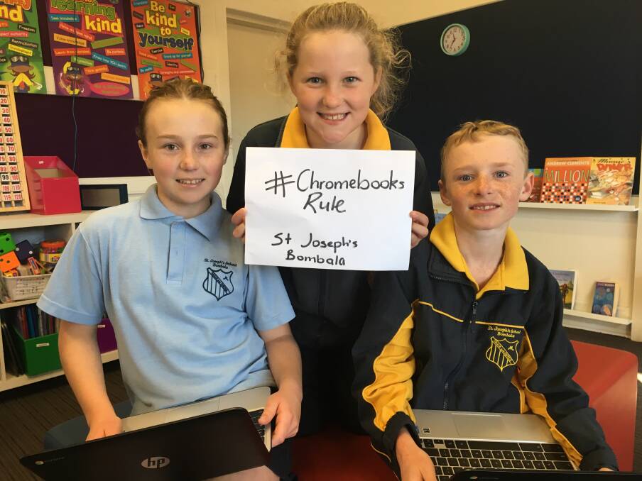 TECH HAPPY: St Joseph's Primary School senior students Lilly Day-Edgecombe, Brylie Stewart and Tait McIntosh are delighted with their new computers.