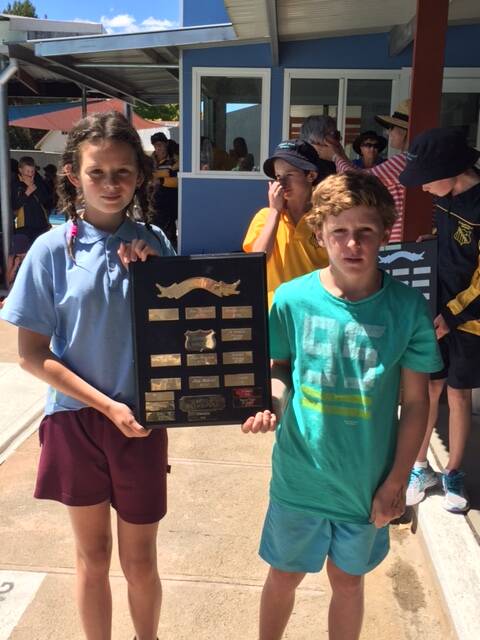 HANDICAP WIN: Bombala Public School swimmers Ashley Marsden and Colby Brownlie holding the handicap trophy won by House Kilarney.