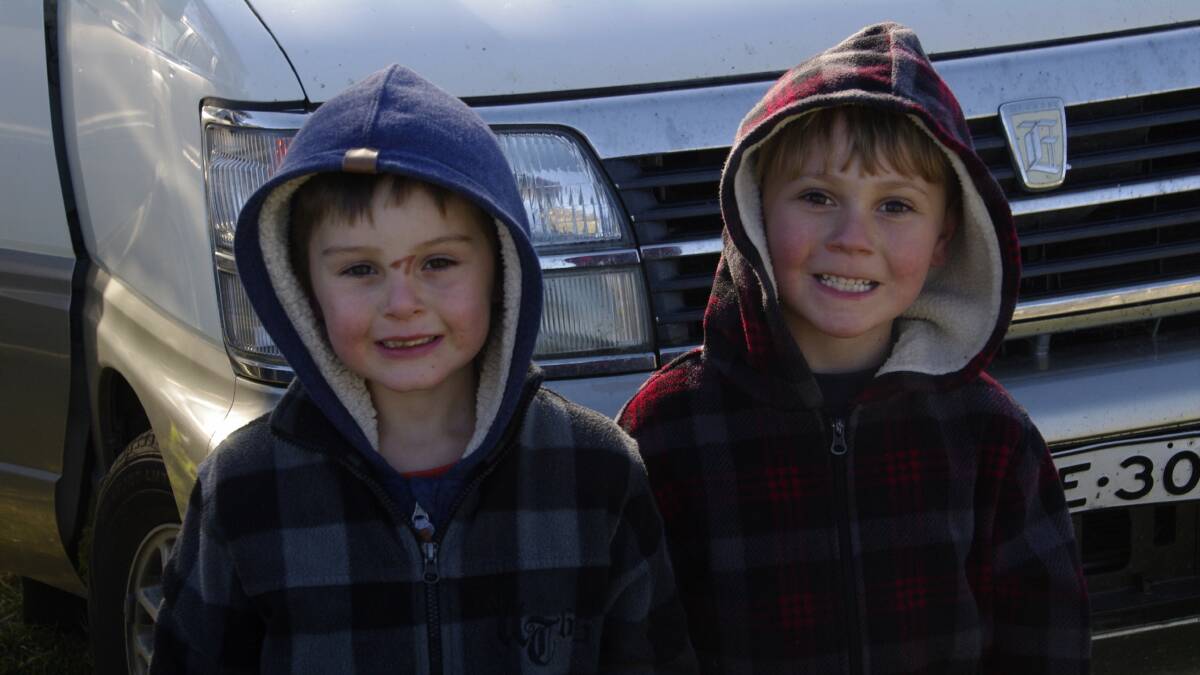 Tyler Radford and Taj Grimsey brave the cold to have some fun at the footy in Bombala on Sunday .