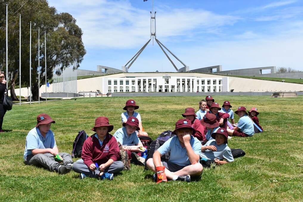 GOVERNMENT LUNCH: Bombala Public School Year 5 students enjoy a picnic lunch in the gardens outside Parliament House on a recent excursion to Canberra.