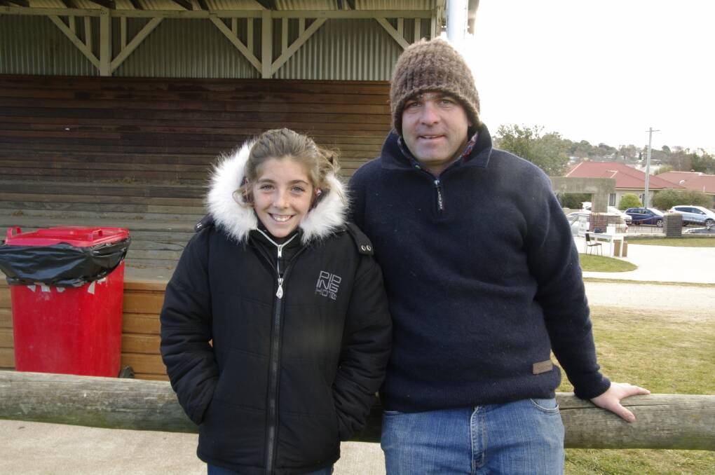 Annie and Matt Green rug up to keep warm while watching the Bombala Blue Heelers play on Saturday in Bombala.