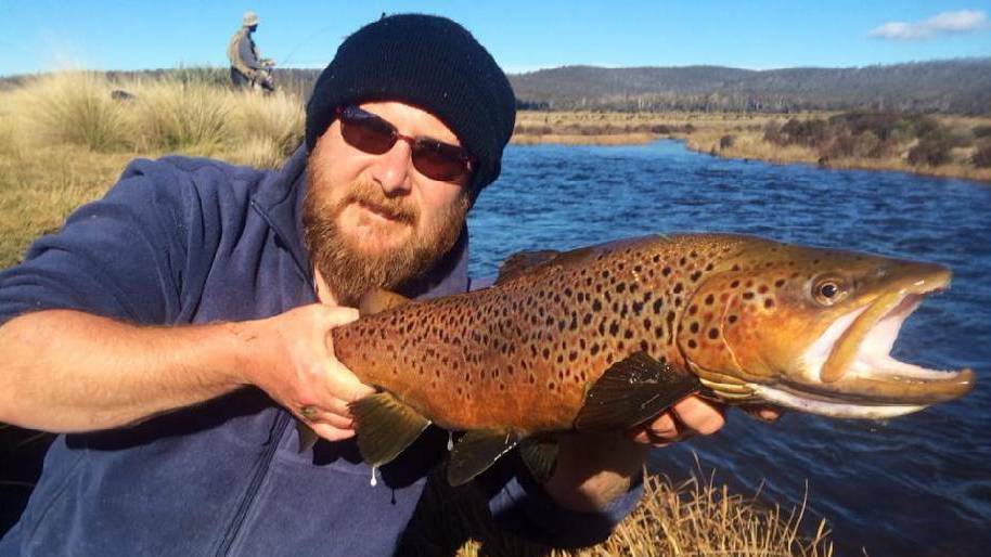Stan Gorton of Narooma with a nice male brown trout caught during the spawning run on the Eucumbene River.