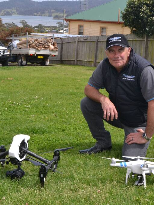 Ian Edwards of South Coast Drones with his latest professional drone or unmanned aerial vehicle on the left and a smaller amatuer model less than 2kg covered by the new CASA legislation.