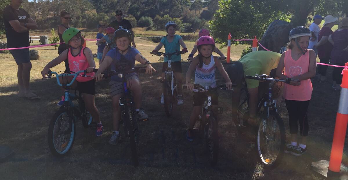 JUNIOR CYCLISTS: Junior bike riders prepare to start the cycle section in Saturday's Australia Day triathlon which organisers said had attracted more entries this year.