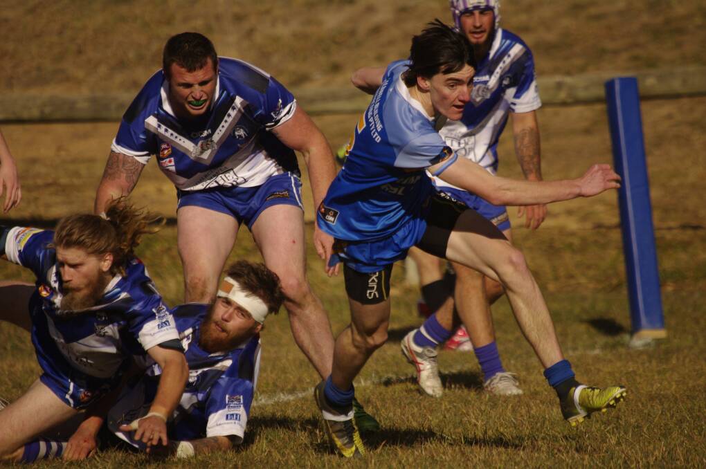 ANOTHER TRY: Bombala's Nick Rosten gets ready to ground the ball and score in the Blue Heelers preliminary final against the Merimbula/Pambula Bulldogs on Sunday.