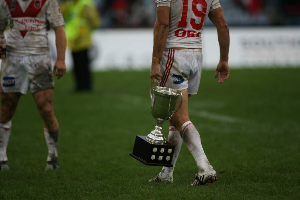 The St George Illawarra Dragons carry off the Anzac Day trophy in 2008. Is playing sport on Anzac Day more about the codes themselves rather than the memory of our fallen soldiers.Picture: STEVE CHRISTO