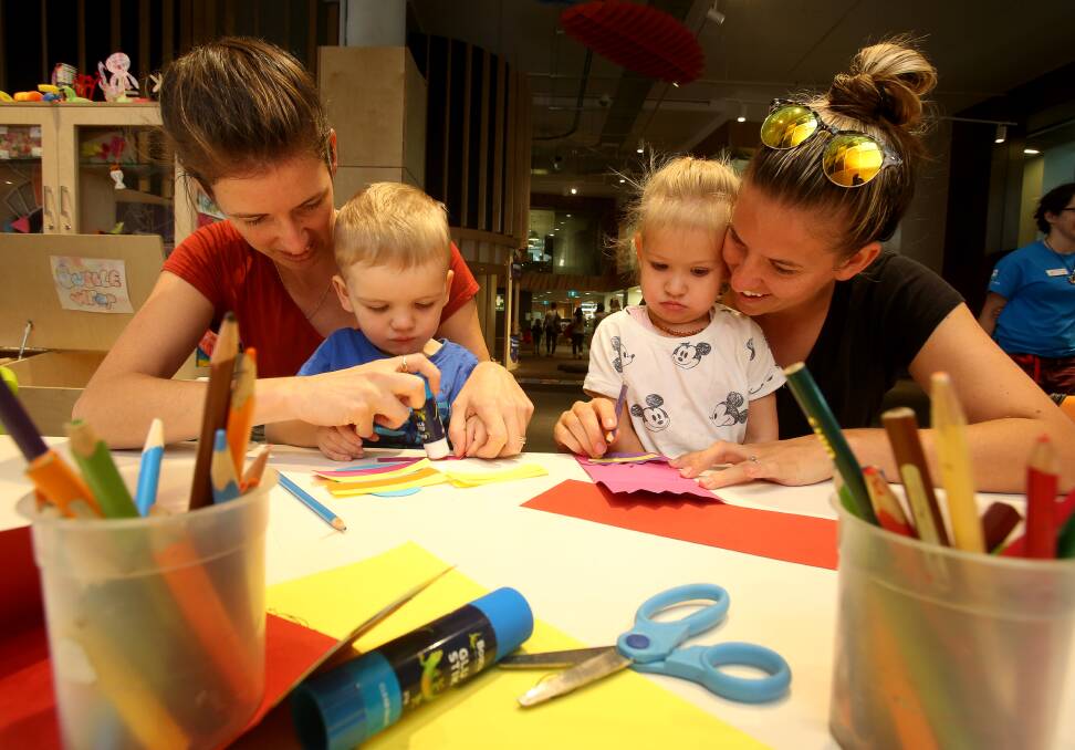 CRAFTWORK: Renee Burgess and Benjamin Burgess with Mila Brailey and Nicole Brailey doing Easter craft at the UOW Early Start Discovery Space. Picture: Robert Peet