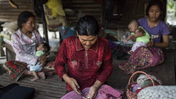 A woman prepares antiretroviral medication for her HIV-positive mother in Roka, Cambodia. They will never receive the attention or treatment enjoyed by Charlie Sheen. Photo: Nicholas Axelrod