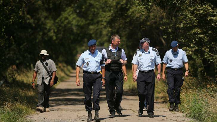 Australian Federal Police officer Brian McDonald (second from right) talks with his Dutch counterpart. Photo: Kate Geraghty