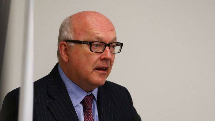 Attorney-General George Brandis could soon have sweeping powers to force phone and internet providers such as Telstra and Optus to do whatever the government wants. Photo: Daniel Munoz