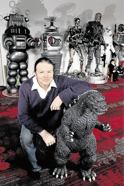 Collector Mark Damon of Devonport, with his Godzilla replica and a selection of life size figurines.