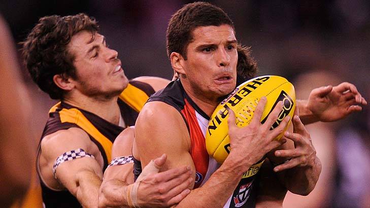 Hawthorn's Brad Sewell and Isaac Smith tackle St Kilda's Leigh Montagna in August last year. Photo: Sebastian Costanzo