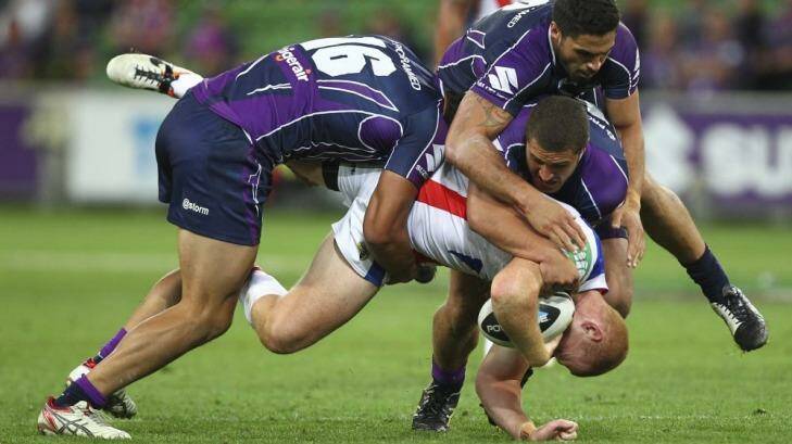 Tragic: Alex McKinnon falls awkwardly in three-man Storm tackle. Photo: Getty-Images