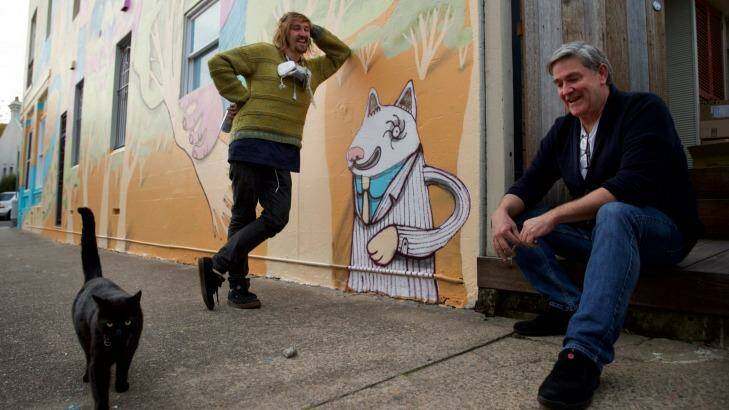 "The more you restrict the freedom of artists to create the imagery they choose, the more you force out the true grittiness of the culture," street artist Birdhat (left) with cafe owner Dale Chaffey. Photo: Wolter Peeters