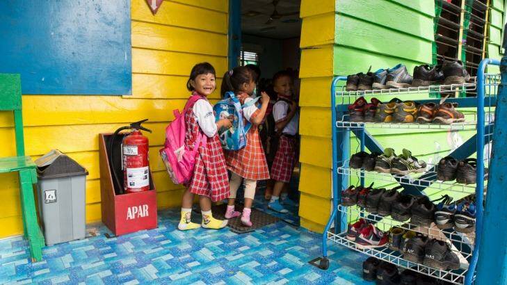 Children remove their shoes before they enter the classroom at Global Andalan school in Riau province. As part of the Fire-Free Villages program, APRIL is starting to reach out to school children.  Photo: Rodrigo Ordonez
