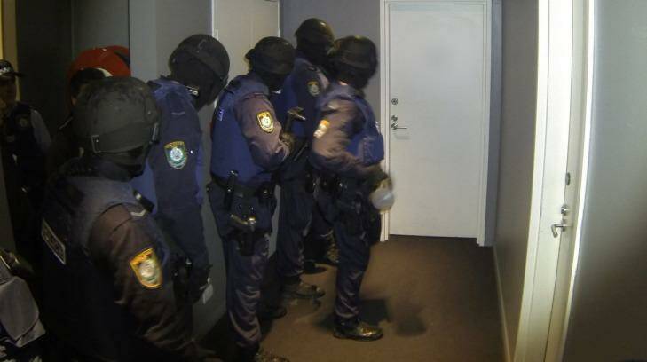 Police carry out one of the early morning raids. Photo: NSW Police Media