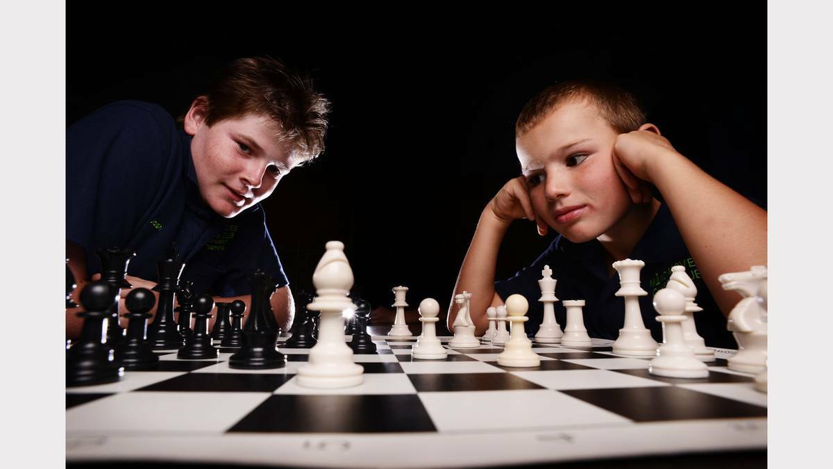 Mind Moves Chess Club: Josh Walker-Davis, 12, and Liam Rose-Nel, 8, prepare up for the upcoming chess competition. Photo: SCOTT GELSTON