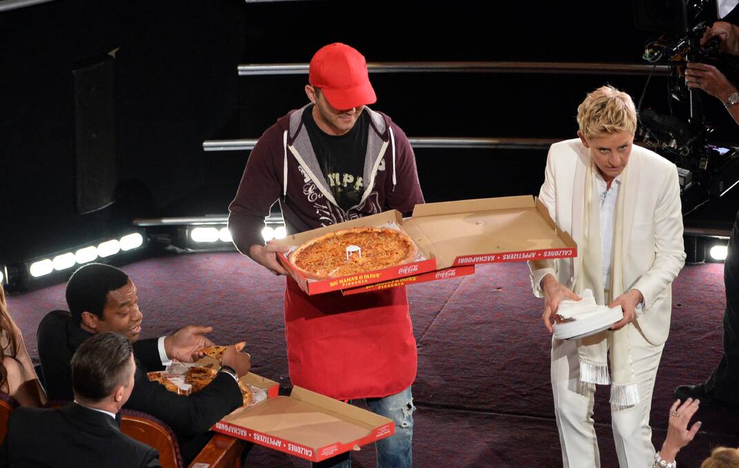 Host Ellen DeGeneres (R) and actor Chiwetel Ejiofor (L) with pizza delivery man in the audience during the Oscars at the Dolby Theatre on March 2, 2014 in Hollywood Photo: GETTY IMAGES