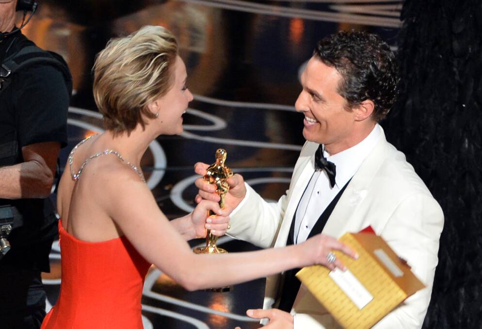  Actor Matthew McConaughey (R) accepts the Best Performance by an Actor in a Leading Role award for 'Dallas Buyers Club' from actress Jennifer Lawrence (L) onstage during the Oscars at the Dolby Theatre on March 2, 2014 in Hollywood Photo: GETTY IMAGES