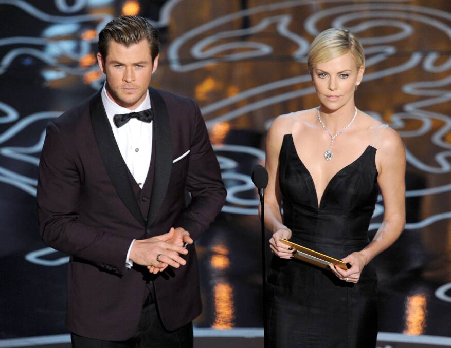 Actors Chris Hemsworth (L) and Charlize Theron speak onstage during the Oscars at the Dolby Theatre on March 2, 2014 in Hollywood Photo: GETTY IMAGES