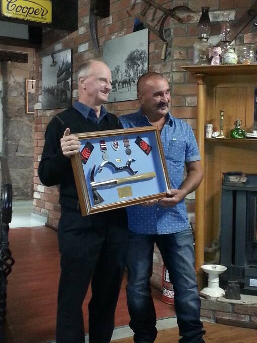 Ossie Benson receives his parting gift from Terry Lomas.