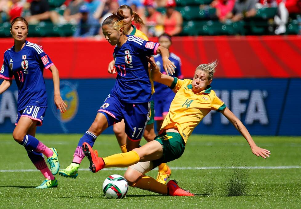GAME ON: Alanna Kennedy challenges Yuki Ogimi during the FIFA Women's World Cup Canada 2015 quarter final match. Photo: Kevin C. Cox/Getty Images